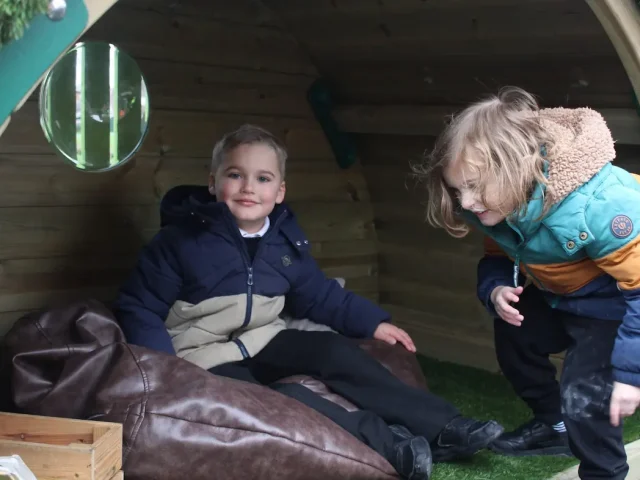 Children reading together in Hobbit House Den